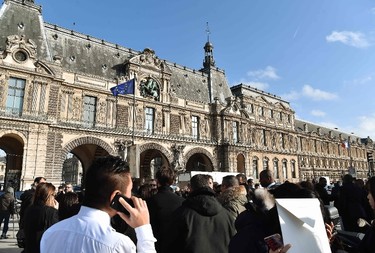 People stand in front of the Louvre museum on February 3, 2017 in Paris after a soldier has shot and gravely injured a man who tried to attack him. "Serious public security incident under way in Paris in the Louvre area," the interior ministry tweeted on February 3 as streets in the area were cordoned off to traffic and pedestrians.  / AFP PHOTO / ALAIN JOCARDALAIN JOCARD/AFP/Getty Images