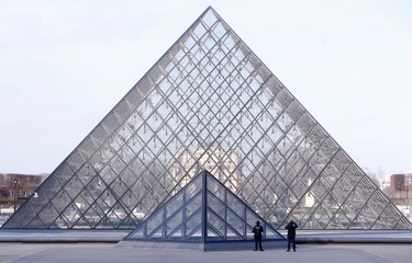 Police officers patrol at the pyramid outside the Louvre museum in Paris,Friday, Feb. 3, 2017. Paris police say a soldier has opened fire outside the Louvre Museum after he was attacked by someone, and the area is being evacuated. (AP Photo/Thibault Camus) ORG XMIT: PAR118