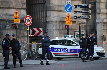 Police officers cordon off the area outside the Louvre museum near where a soldier opened fire after he was attacked in Paris, Friday, Feb. 3, 2017. Police say the soldier opened fire outside the Louvre Museum after he was attacked by someone, and the area is being evacuated. (AP Photo/Christophe Ena) ORG XMIT: TH116