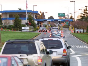 Vehicles line up to enter the United States at the border crossing between Blaine, Washington and White Rock, British Columbia.