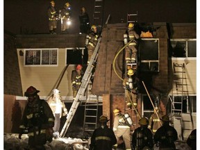 Firefighters at scene of fire at 1500 Caldwell Ave. on March 31, 2008. Khalid Ali, 2, died in the blaze. MIKE CARROCCETTO / POSTMEDIA