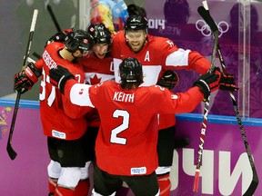 Team Canada's Sidney Crosby celebrates a goal with teammates during the 2014 Olympics in Sochi, Russia. (Al Charest/Calgary Sun)