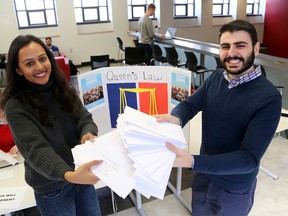 Queen's University law students Alyssa Moses and Yamen Fadel on Thursday with letters written by law students for Ahmed Hussen, the federal Minister of Immigration, Refugees and Citizenship asking for action against the United States travel ban on people from Muslim countries. (Ian MacAlpine/The Whig-Standard)