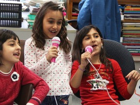 Rahaf Khalifah, 6, left, Rahaf Al-Khalil, 7, and Raghd Al-Khalil, 9, sing along with a song streamed from YouTube at Lunar Love Fest in Sarnia Friday. The event, combining aspects of the lunar new year and Valentine's Day, was one in a series of welcoming events via the YMCA and Sarnia-Lambton Local Immigration Partnership for newcomer kids. (Tyler Kula/Sarnia Observer)