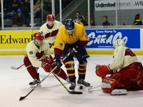 Queen’s Gaels’ Henry Thompson can’t control the puck in front of Royal Military College Paladins goalie Matthew Murphy as defenceman Eric Bouchard attempts to help during the annual Carr-Harris Challenge Cup game at the Rogers K-Rock Centre on Thursday night. (Ian MacAlpine/The Whig-Standard)