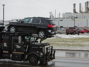 A truck carrying GMC Terrains drives past the Cami Assembly plant where they are built in Ingersoll. Terrain production is moving to Mexico, and GM has announced as many as 625 workers will be laid off at Cami. (MIKE HENSEN, The London Free Press)