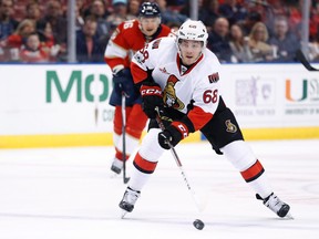 Ottawa Senators left winger Mike Hoffman takes a shot as he is pursued by Florida Panthers left winger Jussi Jokinen during an NHL game on Jan. 31, 2017. (AP Photo/Wilfredo Lee)