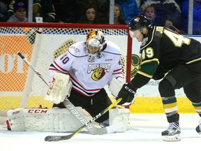 Max Jones of the Knights holds on to the puck as he tries to out wait Owen Sound Attack goaltender Michael McNiven but McNiven stopped the shot when it finally came on Friday February 3, 2017 at Budweiser Gardens. (MIKE HENSEN, The London Free Press)