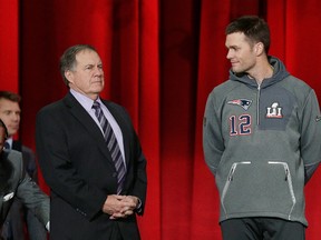 Head coach Bill Belichick of the New England Patriots and Tom Brady stand onstage during Super Bowl 51 Opening Night at Minute Maid Park on Jan. 30, 2017 in Houston. (Bob Levey/Getty Images)