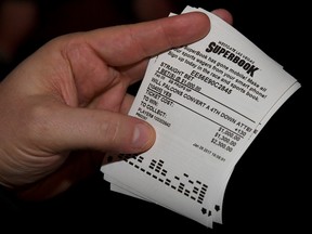 A bettor displays a betting ticket after placing wagers on some of the more than 400 proposition bets for Super Bowl LI between the Atlanta Falcons and the New England Patriots at the Race & Sports SuperBook at the Westgate Las Vegas Resort & Casino on Jan. 26, 2017. (Ethan Miller/Getty Images)