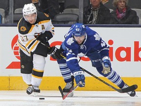 Patrice Bergeron of the Boston Bruins battles against Nazem Kadri of the Toronto Maple Leafs during an NHL game at the Air Canada Centre on Oct. 25, 2014. (CLAUS ANDERSEN/Getty Images files)
