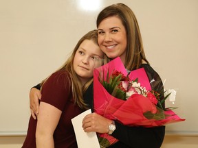 Sudbury native Lianne Henri, right, hugs her late cousin's daughter, Sophie Henri, 19, during a cheque presentation at Health Sciences North in Sudbury, Ont. on Friday February 3, 2017. Leanne shared her story about climbing to the Mount Everest base camp last December to honour the memory of her cousin, Anne Henri. Anne was a NEO Kids nurse who passed away in December 2015. Lianne completed the 12-day expedition to Nepal where she trekked more than 5,000 metres to the Everest base camp to celebrate her cousin's life and spread some of her ashes at the base camp. She created a Go Fund Me page where she shared her journey and collected more than $2,000 for NEO Kids. The donation will go to NEO Kids outpatient clinics and resources and support services for children in northeastern Ontario. John Lappa/Sudbury Star/Postmedia Network