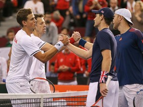 Dominic Inglot and Jamie Murray of Great Britain shake hands with Vasek Pospisil and Daniel Nestor of Canada after their win during the Davis Cup at TD Place Arena on Feb. 4, 2017 in Ottawa. (Andre Ringuette/Getty Images)