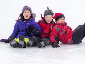 The Watkins kids from left, Emma, 7, Sean, 5, and Draden, 9, loved Winterlude’s giant ice slide in Jacques Cartier Park Saturday.