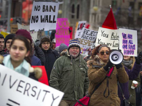 Protesters march down up Elgin Street toward the U.S. embassy on Sussex Drive.