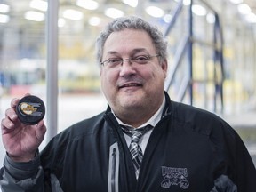 Whitecourt Wolverines head coach Gord Thibodeau shows off the game puck from his 833rd Alberta Junior Hockey League win at the Casman Centre in Fort McMurray Alta. on Friday February 3, 2017. Thibodeau passed Don Phelps's mark of 832 AJHL wins Friday with the Wolverines 2-1 overtime win over the Fort McMurray Oil Barons, making him the winningest coach in league history.