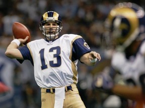 In this Feb. 3, 2002, file photo, St. Louis Rams quarterback Kurt Warner looks to pass to Marshall Faulk in the first quarter against the New England Patriots in Super Bowl 36 in New Orleans. (AP Photo/Doug Mills, File)
