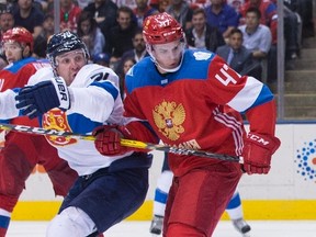 Leo Komarov of Finland (left) and Alexey Marchenko of Russia were opponents during the World Cup of Hockey last September, but now will be teammates on the Maple Leafs. (CHRIS YOUNG/The Canadian Press files)