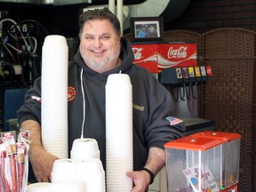 Jake Cherski holds two stacks of empty soup bowls at Philly Cheese Jake's on Saturday, Feb. 4, 2017 in Sarnia, Ont. Cherski has launched a pay-it-forward meal program called Souper Bowl.