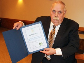 Plympton-Wyoming Mayor Lonny Napper holds up the community appreciation award for the late Keith Murray at the Camlachie Community Centre on Saturday, Feb. 4, 2017 in Camlachie, Ont. Napper, who was close friends with Murray before he died in a plane crash in September 2016, accepted the award his behalf.