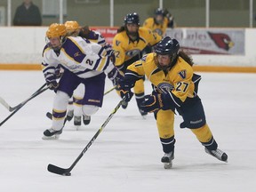 Emma Leger, right, of Laurentian Voyageurs, breaks out of her end during women's OUA hockey action against the Laurier Golden Hawks at the Gerry McCrory Countryside Sports Complex in Sudbury, Ont. on Saturday February 4, 2017. John Lappa/Sudbury Star/Postmedia Network