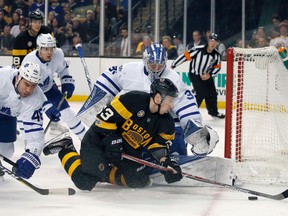 Bruins left wing Brad Marchand (63) falls to the ice while making a play for the puck in front of Maple Leafs goalie Frederik Andersen during second period NHL action in Boston on Saturday, Feb. 4, 2017. (Mary Schwalm/AP Photo)