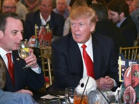 U.S. President Donald Trump watches the Super Bowl with First Lady Melania Trump (R) and White House Chief of Staff Reince Priebus (L) at Trump International Golf Club Palm Beach in West Palm Beach, Florida on February 5, 2017. (MANDEL NGAN/AFP/Getty Images)