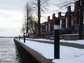 Some of the lights that surround the waterfront path at Commodore's Cove condominiums on King Street West. City staff recommends that the city start paying to maintain the lighting. (Steph Crosier/The Whig-Standard)