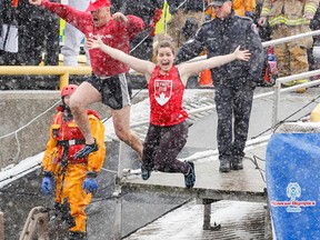 Whig-Standard journalist Steph Crosier and her father Brian take part in the Polar Plunge at Crawford Wharf in Kingston on Sunday. (Julia McKay/The Whig-Standard)