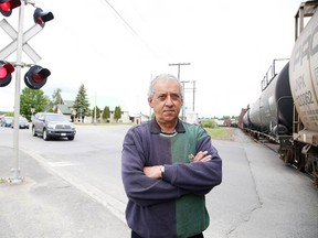 Frank Mazzuca Jr. stands at the level crossing in Capreol in June. Residents have been frustrated with trains holding up traffic for more than 25 minutes. (Gino Donato/Sudbury Star file photo)