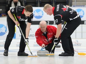 Skip Glenn Howard (centre) is going back to the Brier after winning the Tankard in Cobourg, Ont., on Sunday. (Pete Fisher/Postmedia network)