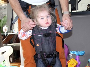 Sofia Glass, 3, tries her new Upsee, purchased by her grandparents. It is hoped the harness will help with her mobility. Diagnosed with the rare neurological disorder Rett syndrome, Sofia isn't able to walk, communicate or hold a bottle. (Jennifer Hamilton-McCharles/Postmedia)