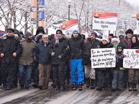 A few hundred people walk to the Quebec legislature at a march in solidarity to the victims of the mosque shooting, Sunday, February 5, 2017 in Quebec City. Leaders of the Muslim community, Mohamed Labidi, third from the left, and Mohamed Yangui, fourth, vice-president and president of the Quebec Islamic Cultural centre, stand together on the front row. Six people died in a shooting at a Quebec City mosque on January 29. THE CANADIAN PRESS/Jacques Boissinot