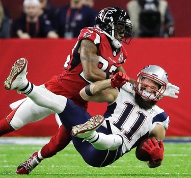 New England Patriots' Julian Edelman is tackled by Atlanta Falcons' Robert Alford during the first half of the NFL Super Bowl 51 football game Sunday, Feb. 5, 2017, in Houston. (AP Photo/Elise Amendola) ORG XMIT: NFL162