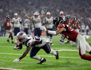 New England Patriots' James White (28) dives to the end zone against Atlanta Falcons' Jalen Collins for a touchdown during the second half of the NFL Super Bowl 51 football game Sunday, Feb. 5, 2017, in Houston. (AP Photo/Mark Humphrey) ORG XMIT: NFL278