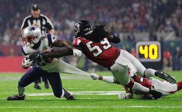 New England Patriots' James White, left, is tackled by Atlanta Falcons' Jalen Collins, bottom, and De'Vondre Campbell during the second half of the NFL Super Bowl 51 football game Sunday, Feb. 5, 2017, in Houston. (AP Photo/Jae C. Hong) ORG XMIT: NFL301