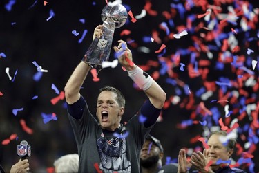 New England Patriots' Tom Brady raises the Vince Lombardi Trophy after defeating the Atlanta Falcons in overtime at the NFL Super Bowl 51 football game Sunday, Feb. 5, 2017, in Houston. The Patriots defeated the Falcons 34-28. (AP Photo/Darron Cummings) ORG XMIT: NFL391