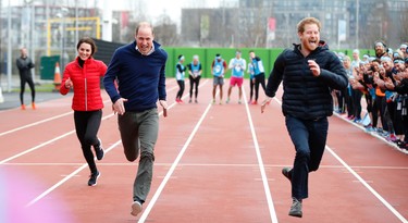 Prince William, second left,  Kate, the Duchess of Cambridge, left, and Prince Harry take part in a relay race, during a training event to promote the charity Heads Together, at the Queen Elizabeth II Park in London, Sunday, Feb. 5, 2017. (AP Photo/Alastair Grant, Pool)