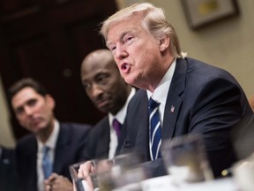 US President Donald Trump meets with leaders of the pharmaceutical industry in the Oval Office at the White House in Washington, DC, on January 31, 2017. / AFP PHOTO / NICHOLAS KAMM