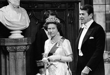 FILE - In this June 8, 1980 file photo, Britain's Queen Elizabeth II and U.S. President Ronald Reagan walk into St. George's Hall at Windsor Castle, England. On Monday Feb. 6, 2017, Queen Elizabeth II marks her Sapphire Jubilee, becoming the first British monarch to reign for 65 years. (AP Photo/File)