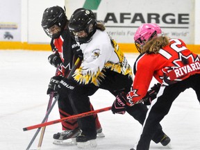 Ava Bree (middle) of the Mitchell U12 ringette team carries the ring through the neutral zone during recent league play against Chatham. ANDY BADER MITCHELL ADVOCATE