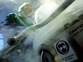A doctor takes out preserved embryos in liquid nitrogen at a clinic in Barcelona. AFP PHOTO/JOSEP LAGO