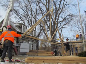 Brentley Belanger, left, a member of Local 1256, helps steady a roof truss as it's lifted into place on a new carriage house under construction at the Children's Animal Farm on Monday February 6, 2017 at Canatara Park in Sarnia, Ont. The $100,000 project is scheduled to be completed in time for a grand opening in early April.
 Paul Morden/Sarnia Observer/Postmedia Network