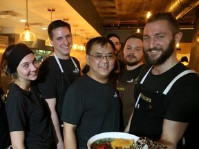 Chef Eric Hanson holds up a Roasted Barley Chicken Bowl ($15) as some of the other staff at Prairie Noodle House at 10350-124 St., in Edmonton have a lighter moment on Tuesday Jan. 26, 2016.