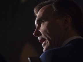 Minister of Finance Bill Morneau speaks with the media in the foyer of the House of Commons, Monday, February 6, 2017 in Ottawa. (THE CANADIAN PRESS/Adrian Wyld)