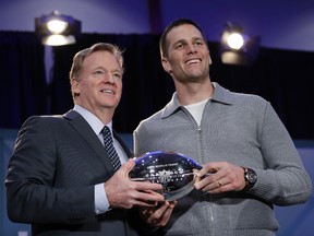 NFL Commissioner Roger Goodell (left) and Patriots quarterback Tom Brady pose with the MVP trophy during a news conference a day after Super Bowl 51 in Houston on Monday, Feb. 6, 2017. Brady was named the MVP of the game. (David J. Phillip/AP Photo)