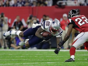 Patriots' Martellus Bennett (left) makes a reception while Falcons' Keanu Neal (right) defends during Super Bowl 51 in Houston on Sunday, Feb. 5, 2017. (Mark Humphrey/AP Photo)