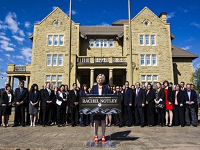 Premier-designate Rachel Notley addresses the media with her caucus behind her during the new NDP government's first caucus meeting at Government House in Edmonton, Alta. on Saturday, May 9, 2015.