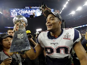 Patriots' Trey Flowers celebrates with the Vince Lombardi Trophy after defeating the Falcons in overtime at Super Bowl 51 in Houston on Sunday, Feb. 5, 2017. (Mark Humphrey/AP Photo)