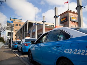 Blue and White cabs line up at the Via Rail station in downtown London. The company has a contract with Via. (Mike Hensen/The London Free Press)